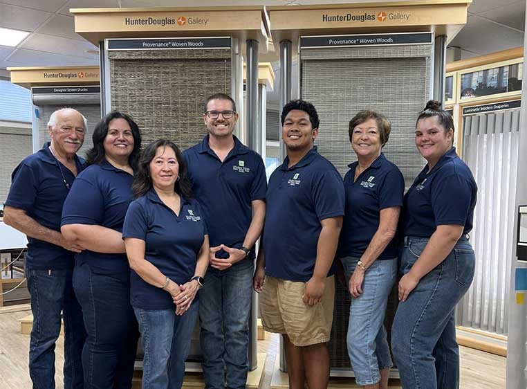 Company staff posing for a photo in the showroom